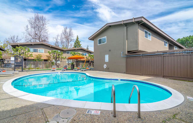 a swimming pool with a house in the background at Element LLC, Sunnyvale, 94086