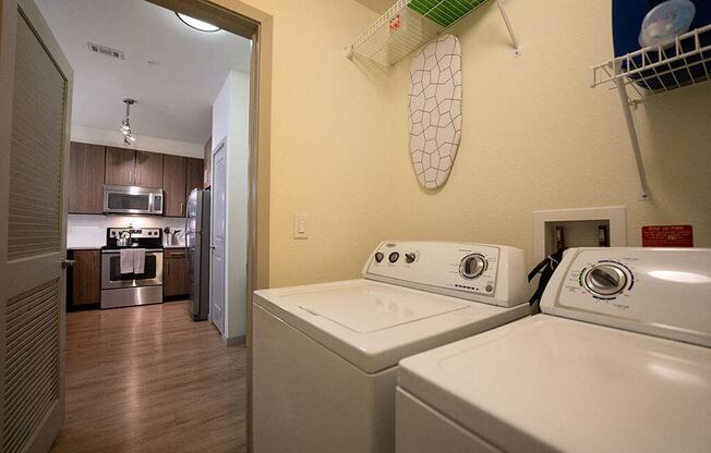 a kitchen with a washing machine and a dryer