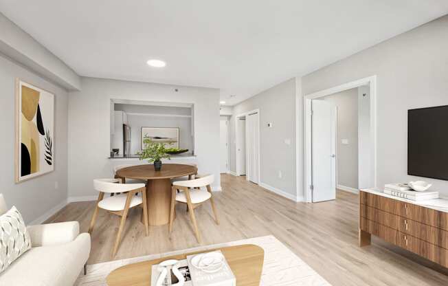a living room and dining room with a table and chairs