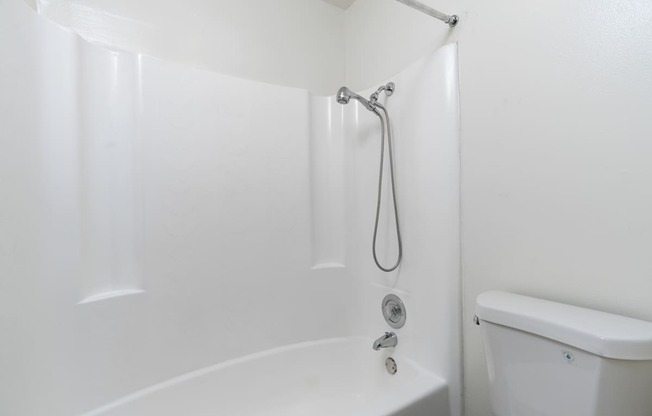 A white bathroom with a tub and shower.