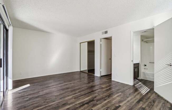 A room with wooden floors and white walls.