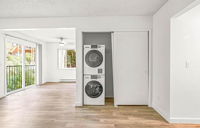 an empty room with a washer and dryer in it