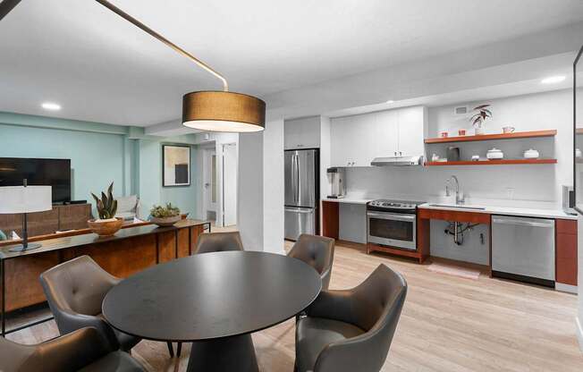 a kitchen and dining room with a table and chairs