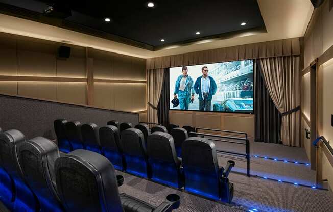 a large screen in front of a group of people on a screen in a room