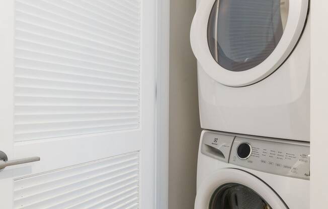 a washer and dryer in a small laundry room at One Ten Apartments, Jersey City , NJ, 07310