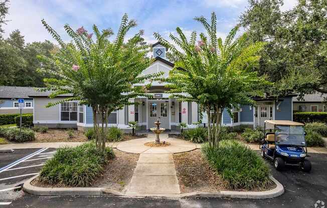 A golf cart is parked in front of a building with a clock tower.