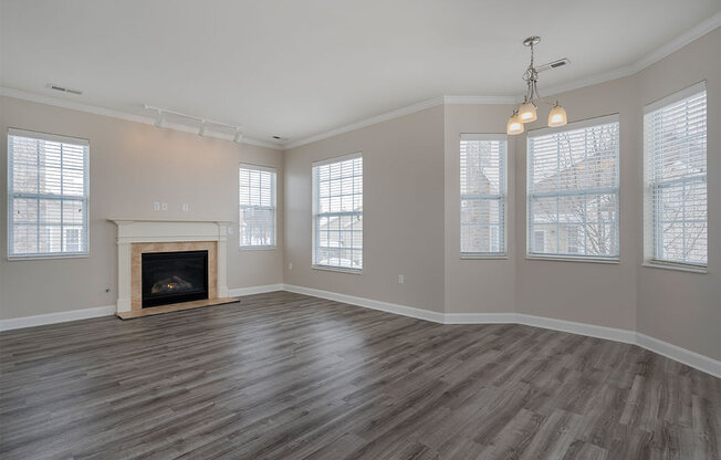 an empty living room with a fireplace