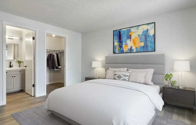 A bedroom with a large bed and a painting above it.