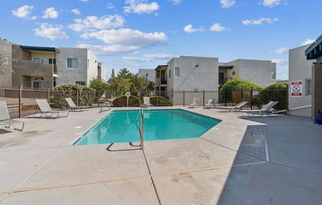 our apartments have a swimming pool and a patio with chairs