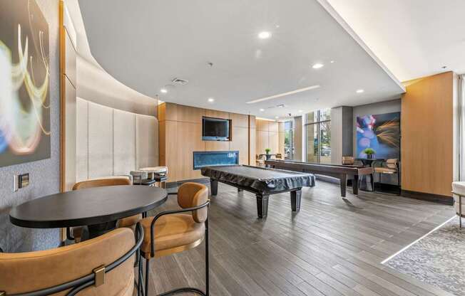 A modern dining room with a round table and chairs.