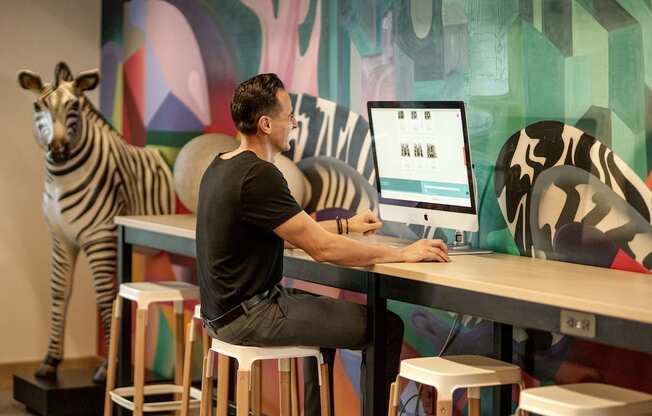 man using computer in lounge at Pixon at Lake Nona Pixon, Florida