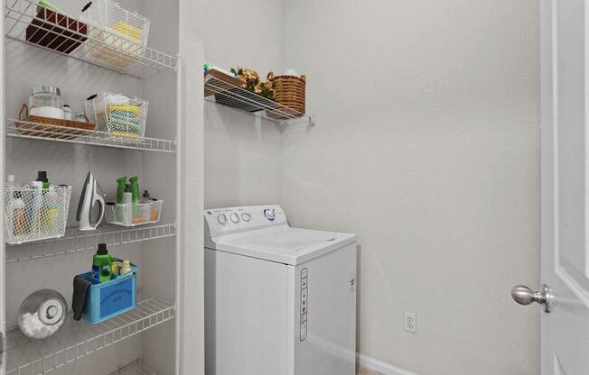 a white washer and dryer in a room with a closet at Stonepost Lakeside, Olathe, Kansas