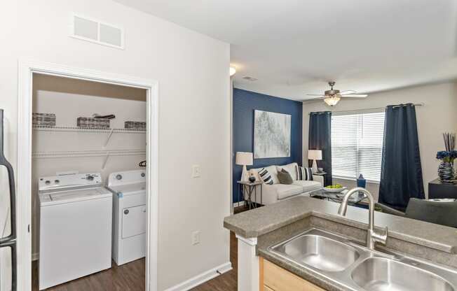 the view of a kitchen and living room with a stove refrigerator and sink