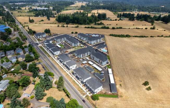 an aerial view of a large commercial building with a highway in front of it