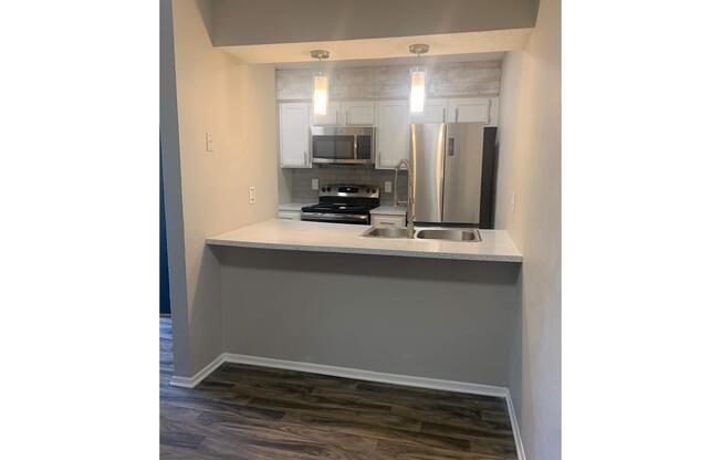 a kitchen with a sink and a mirror