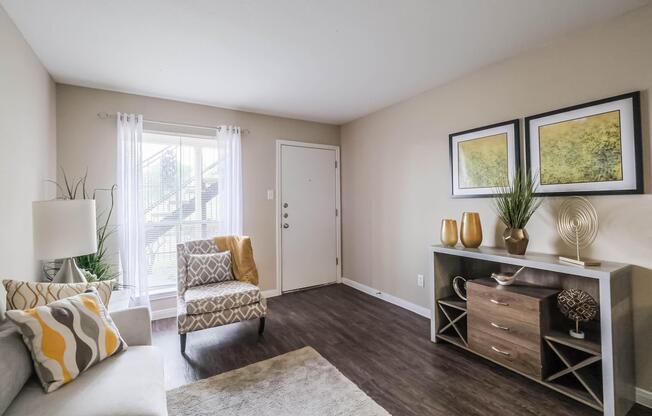 a living room filled with furniture and a large window