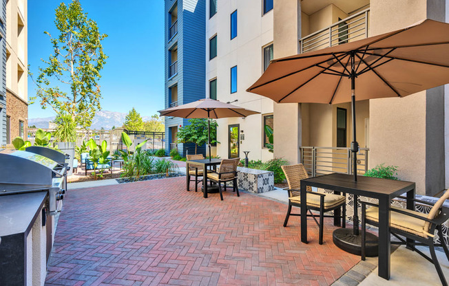 A patio with a table and chairs and an umbrella.