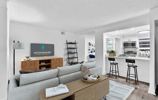 A living room with a grey sofa and a wooden coffee table.