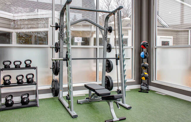 Free weights in fitness center, smith machine