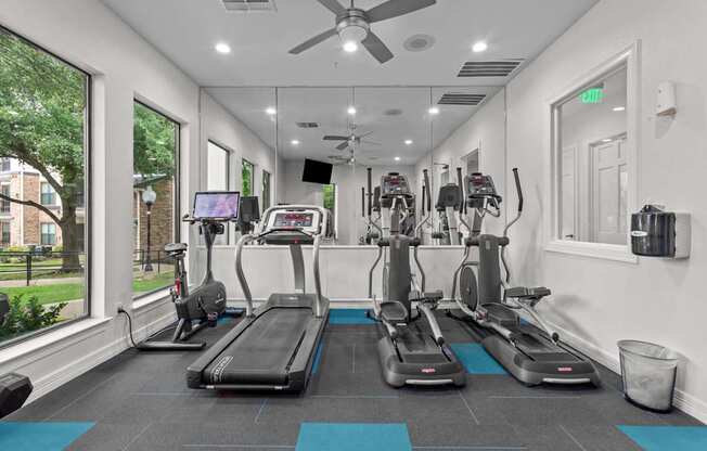 A gym with treadmills and exercise bikes.