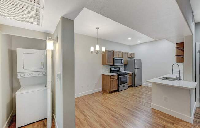 A kitchen with a white oven and a white sink.