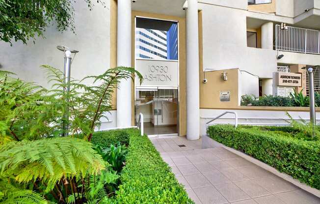 Exterior view of apartment building's building with a sign that says 10930 Ashton.