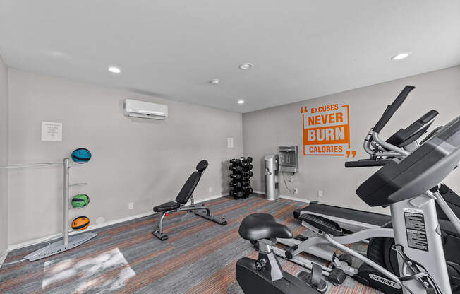 A gym room with a row of exercise bikes and a sign that says