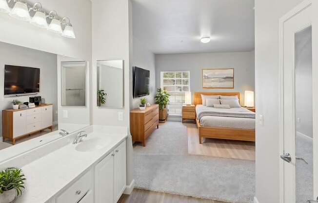 A bedroom with a bed, dresser, and mirror.