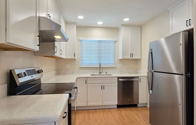 Renovated Home with New Kitchen, Stainless Steel Appliances, Wood Flooring, Fresh Paint, New Driveway, Great Location!