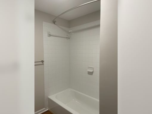 a bathroom with a tub and a shower in it