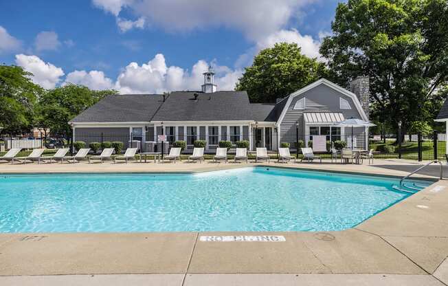 A pool with a building behind it