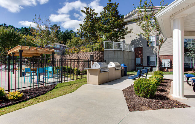 a patio with a table and chairs in front of a house
