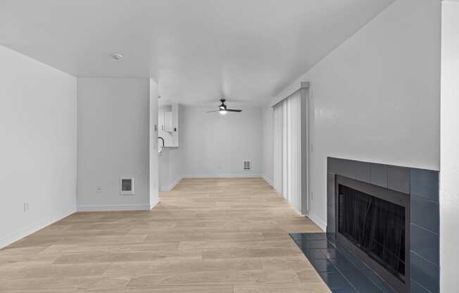 a living room with a fireplace and a wooden floor