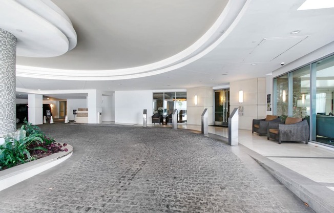 a large lobby with a circular ceiling and a large rug
