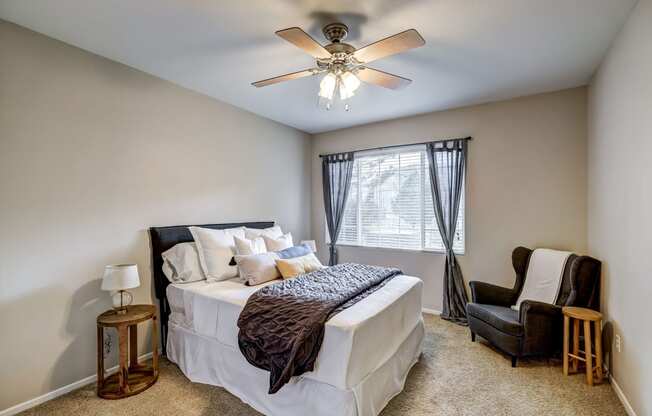 Sonoma Resort at Saddle Rock - Bedroom with Tall 9 ft Ceilings, Large Window, Ceiling Fan, and Beige Carpeting