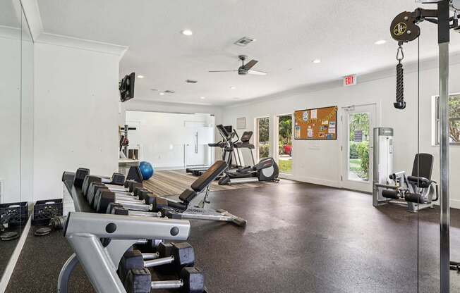 A gym with a variety of equipment including weights and machines.