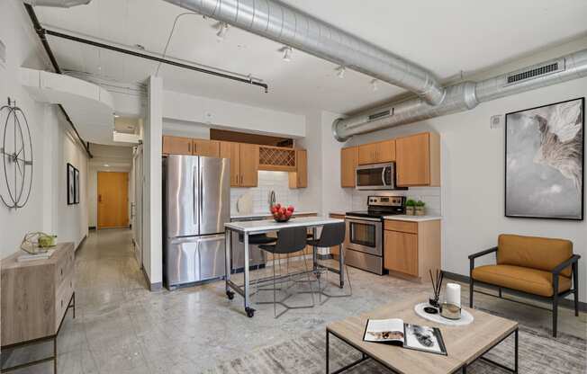 a living room with a kitchen and a table with chairs