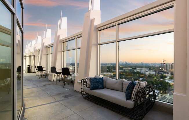 a living room with a couch and a view of a city skyline