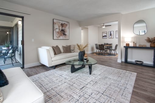 Model Apartment living room with a white couch and a glass coffee table