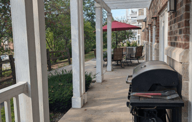 a barbecue grill on the front porch of a house