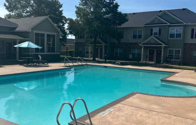 a swimming pool with a building in the background