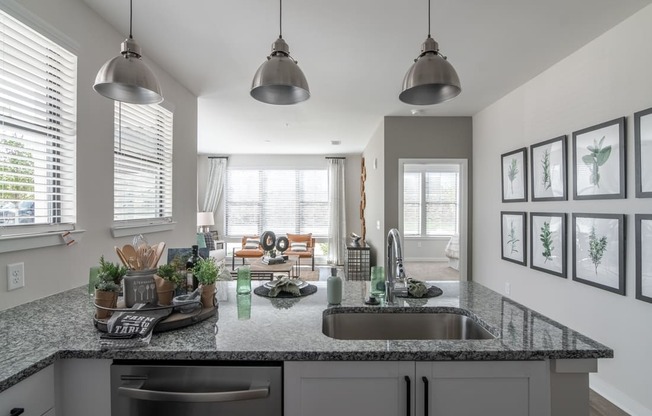 an open kitchen with a sink and a counter top