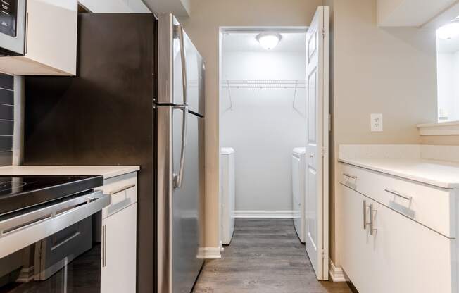 a kitchen with white cabinets and stainless steel appliances at Heritage Bay, Jensen Beach, FL 34957