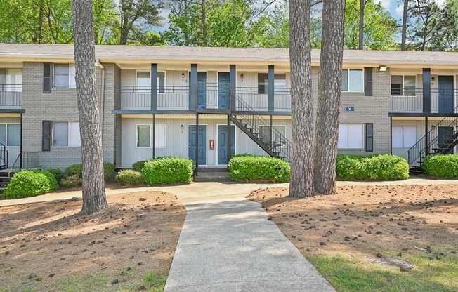 Apartment building exterior at Amber Grove in Marietta Georgia with mature landscaping