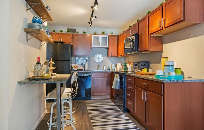 a kitchen with wooden cabinets and a bar with stools
