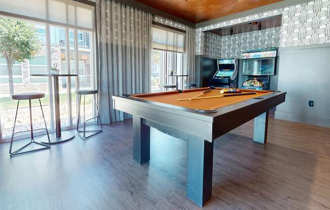 a game room with a pool table and a bar