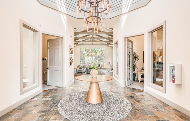 a foyer with a round table and a chandelier at River Pointe, Conroe, TX, 77304