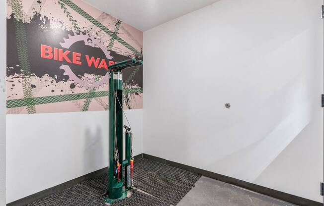 a green bike stand in the corner of a room