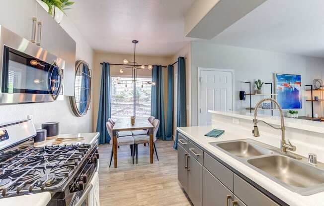 A modern kitchen with a stove top oven and a sink.