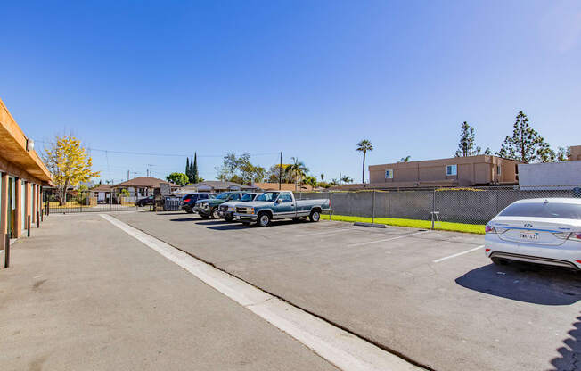 a parking lot with cars parked in front of a building